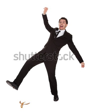 Businessman slipping on banana peel Stock photo © AndreyPopov