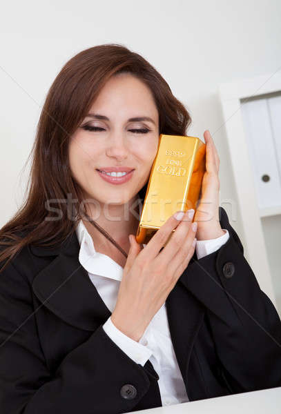 üzletasszony tart aranyrúd portré gyönyörű fiatal Stock fotó © AndreyPopov