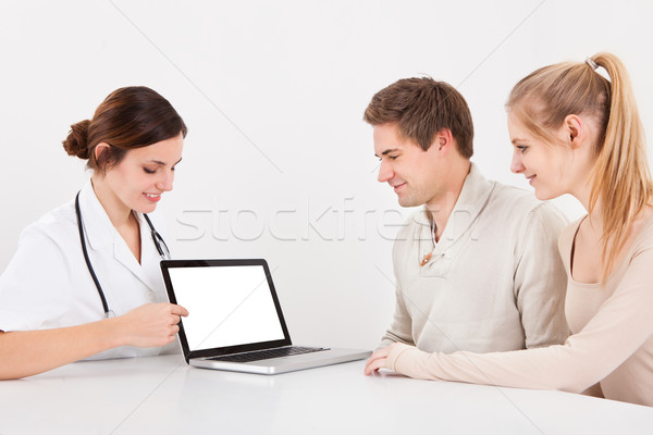 Doctor And Couple With Laptop Stock photo © AndreyPopov