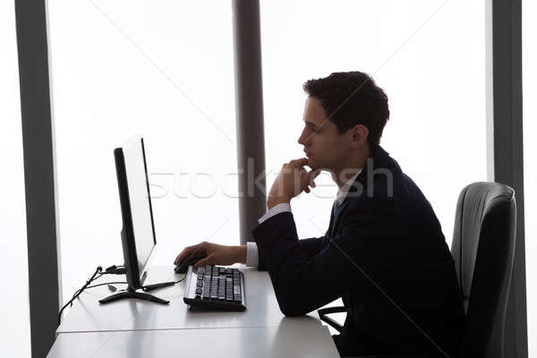 Businessman Using Computer At Office Desk Stock photo © AndreyPopov