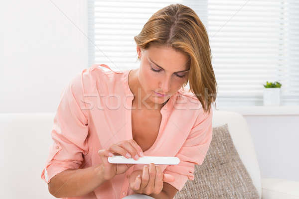 Woman Filing Nails With File Stock photo © AndreyPopov