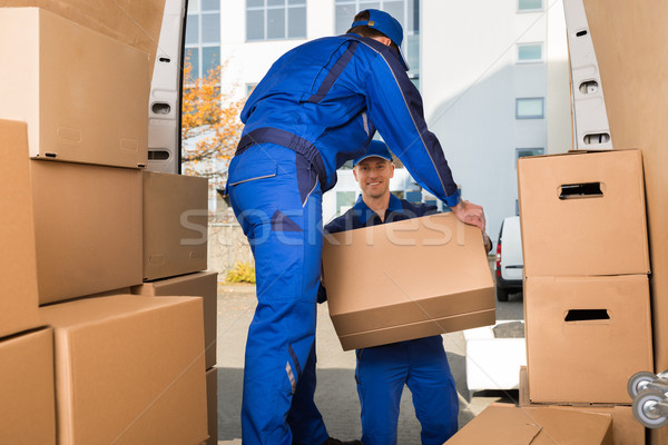 Movers Carrying Sofa Outside Truck On Street Stock photo © AndreyPopov