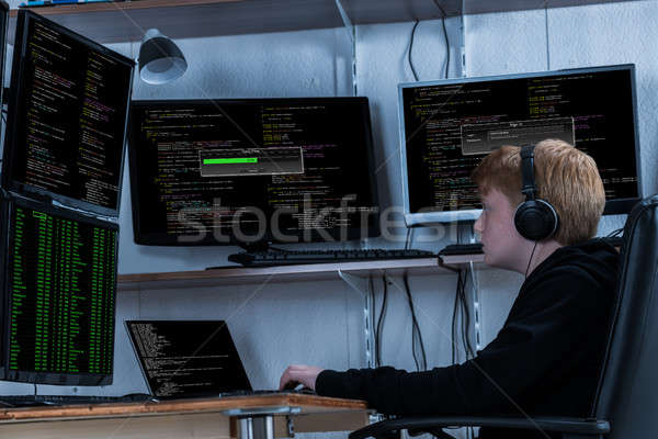 Boy Stealing Data From Multiple Computers Stock photo © AndreyPopov