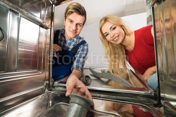 Stock photo: Male Worker Repairing Dishwasher In Kitchen