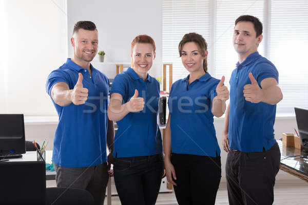 Janitors Showing Thumb Up Sign In The Office Stock photo © AndreyPopov