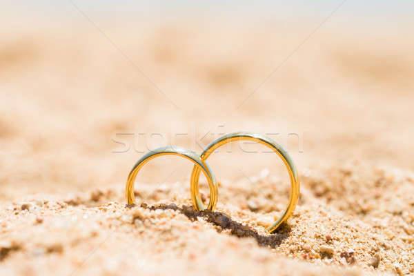 Two Golden Rings In Sand Stock photo © AndreyPopov
