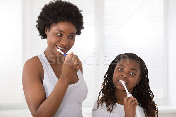 Mother And Daughter Brushing Their Teeth Stock photo © AndreyPopov