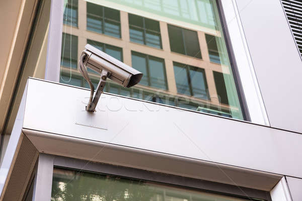 Security camera mounted on office building in city Stock photo © AndreyPopov