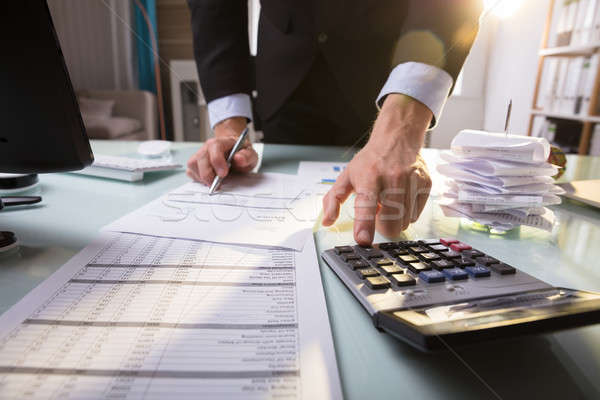 Businessperson Calculating Invoice Stock photo © AndreyPopov