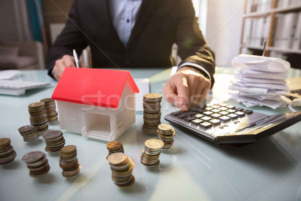 Close-up Of Stacked Coins And House Model Stock photo © AndreyPopov