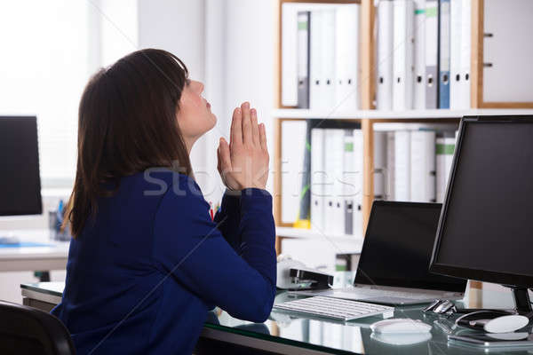 Businesswoman Looking Up With Praying Gesture Stock photo © AndreyPopov