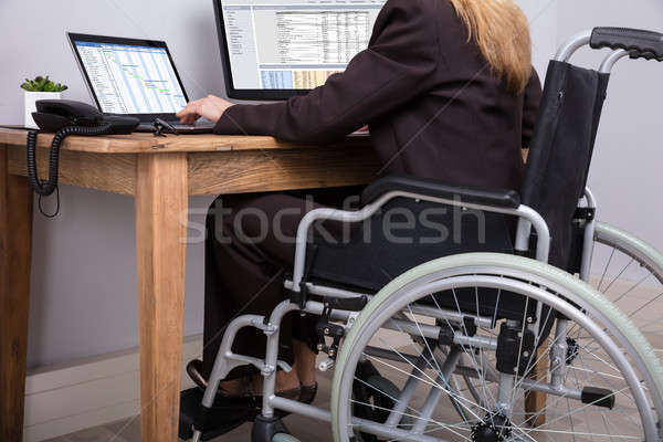 Mozgássérült üzletasszony dolgozik számítógép hátsó nézet ül Stock fotó © AndreyPopov