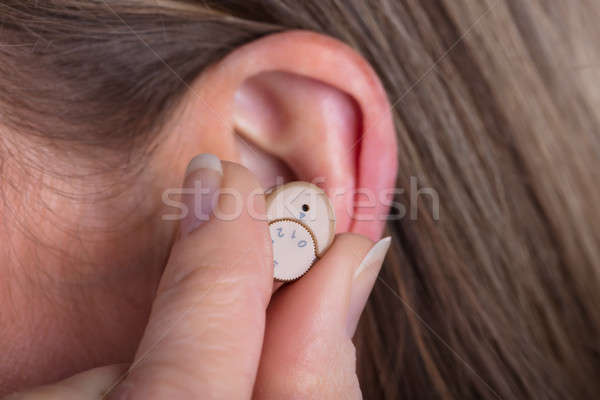 Woman Wearing Hearing Aid Stock photo © AndreyPopov