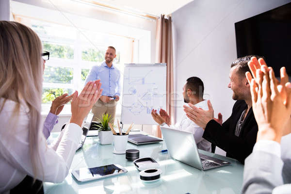 Businesspeople Applauding Their Colleague After Presentation Stock photo © AndreyPopov