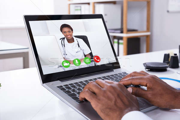 Person Video Conferencing With Female Doctor Through Laptop Stock photo © AndreyPopov