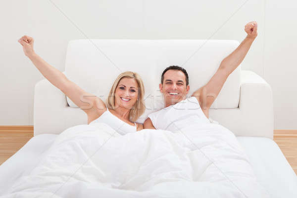 Couple Waking Up In Bed Stock photo © AndreyPopov