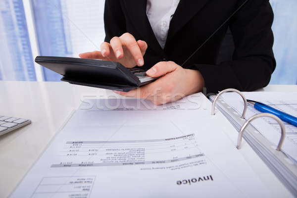 Businesswoman Calculating Tax Stock photo © AndreyPopov