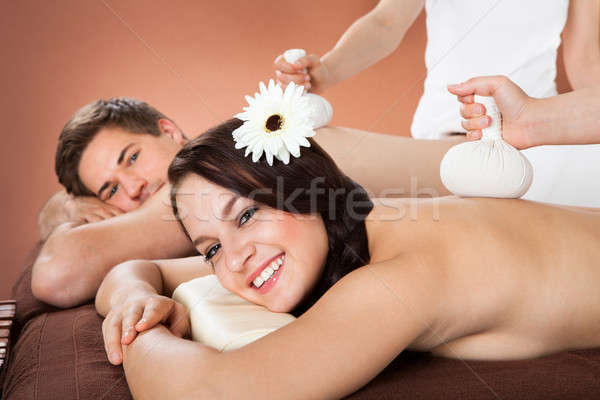 Couple Receiving Massage With Herbal Compress Balls Stock photo © AndreyPopov