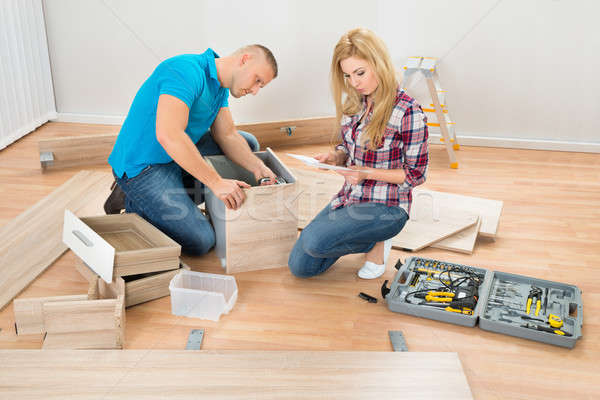 Couple Assembling Wooden Drawers Stock photo © AndreyPopov