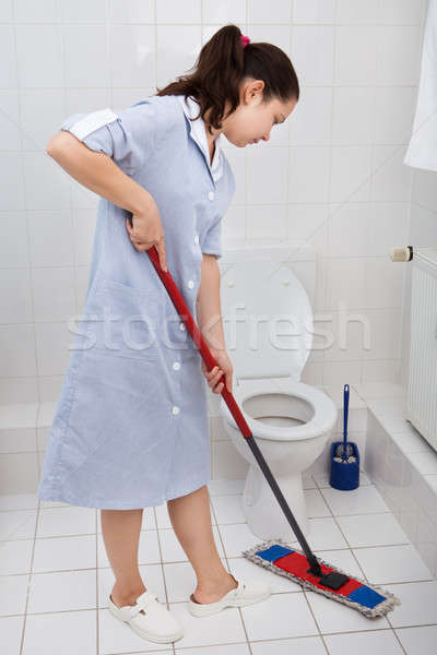Fiatal szobalány takarítás wc portré egyenruha Stock fotó © AndreyPopov