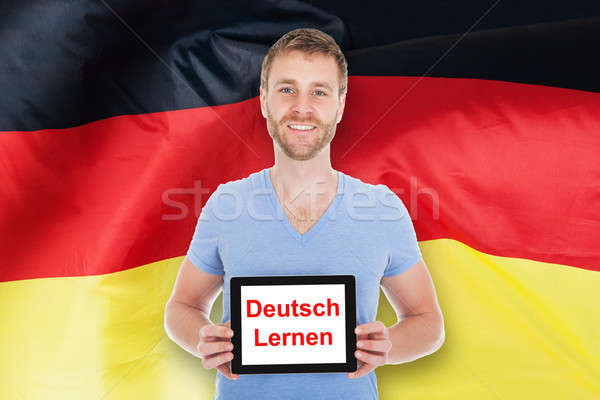 Man Holding Digital Tablet With Learn German Text Stock photo © AndreyPopov