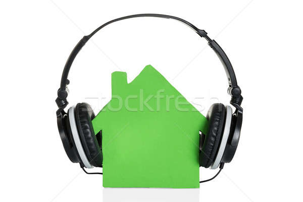 Stock photo: Green House Model With Headphone