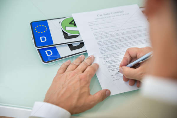 Businessman Filling Car Sale Contract Form Stock photo © AndreyPopov