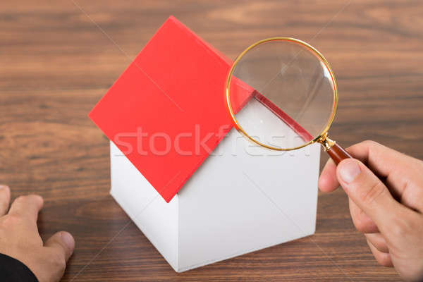 Person Hands With Magnifying Glass And Model House Stock photo © AndreyPopov