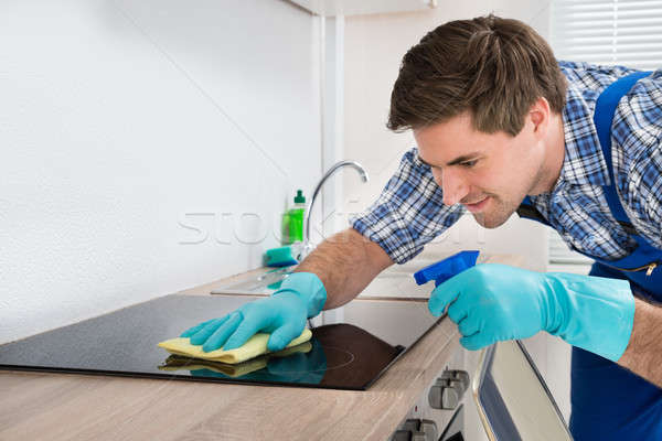 Janitor Cleaning Induction Stove Stock photo © AndreyPopov