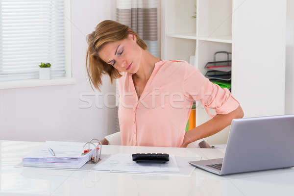 Młoda kobieta cierpienie ból w krzyżu podatku biurko komputera Zdjęcia stock © AndreyPopov