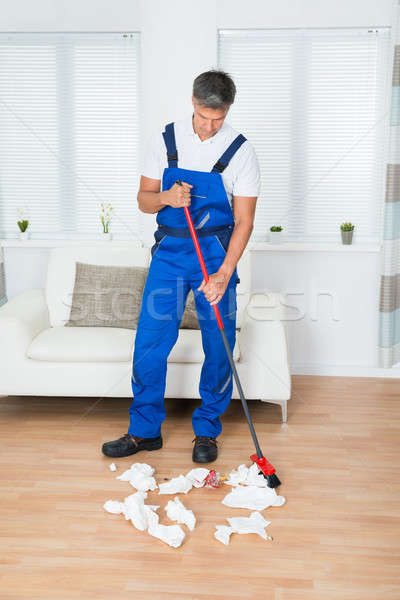 Janitor Sweeping Crumpled Papers On Floor Stock photo © AndreyPopov