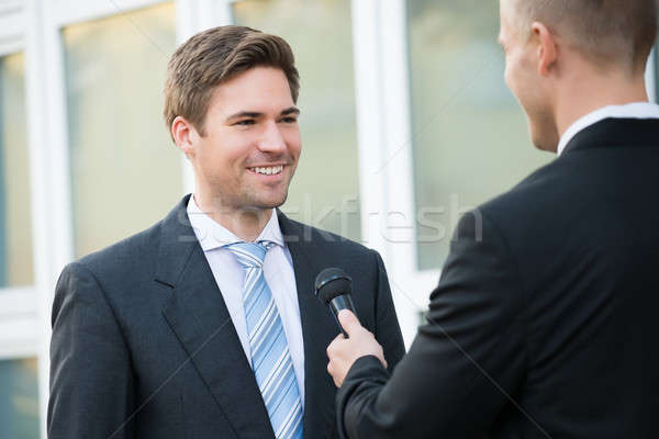 Journalist interview gelukkig zakenman achteraanzicht Stockfoto © AndreyPopov