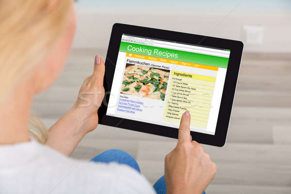 Woman Using Digital Tablet For Learning Recipe Stock photo © AndreyPopov