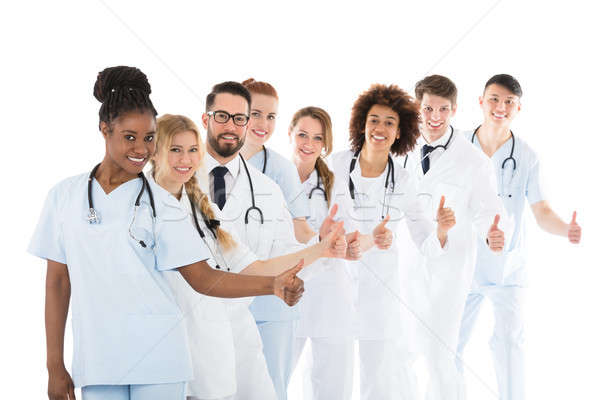 Smiling Medical Team Gesturing Thumbs Up Stock photo © AndreyPopov