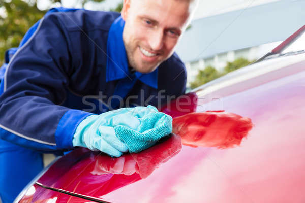 Happy Male Worker Cleaning Red Car Stock photo © AndreyPopov