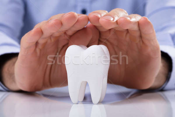 Man's Hand Protecting White Tooth Stock photo © AndreyPopov