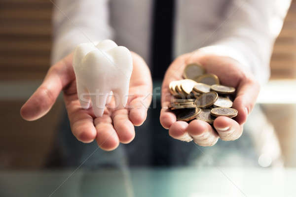  Person Holding White Tooth And Golden Coins Stock photo © AndreyPopov