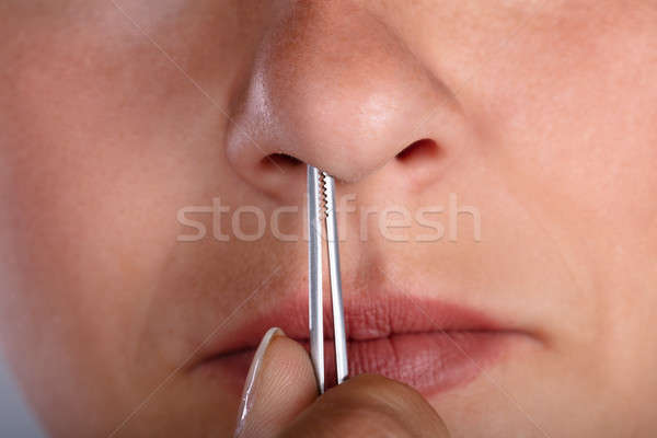 Woman Plucking Her Nose Hair Stock photo © AndreyPopov