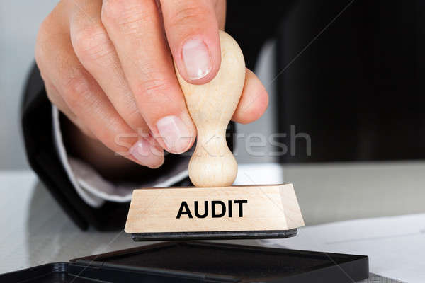 Hand Holding Rubber Stamp With Audit Sign Stock photo © AndreyPopov