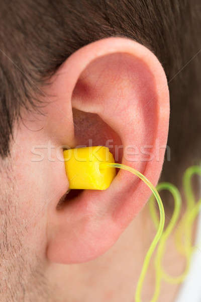 Yellow Earplug Into The Ear Stock photo © AndreyPopov