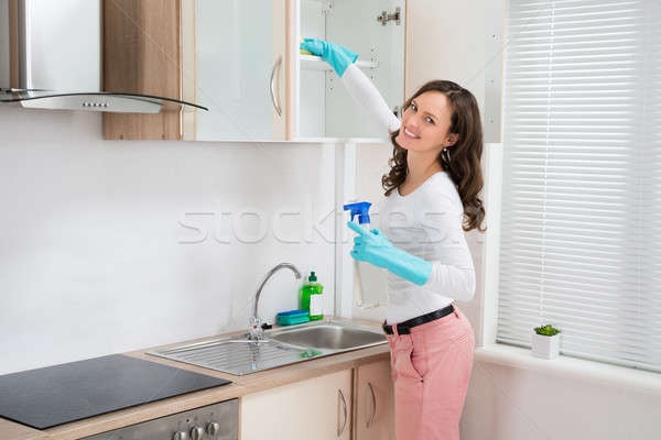 Nő takarítás polc fiatal nő rongy mosószer Stock fotó © AndreyPopov
