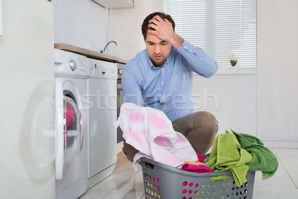 Man With Laundry Basket Holding Stained Cloth Stock photo © AndreyPopov