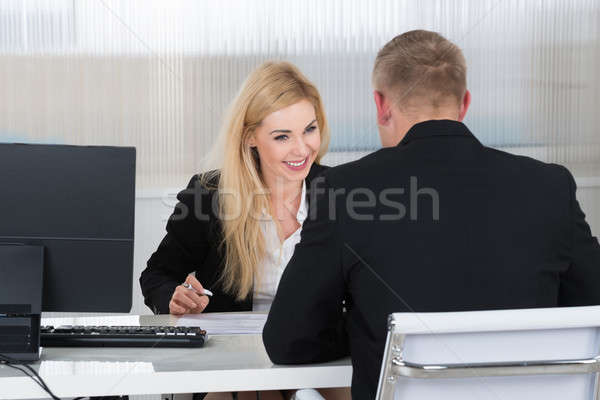 Businesswoman Interviewing Male Candidate At Desk Stock photo © AndreyPopov