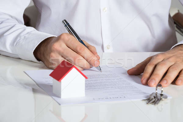 Businessman Signing House Contract Stock photo © AndreyPopov