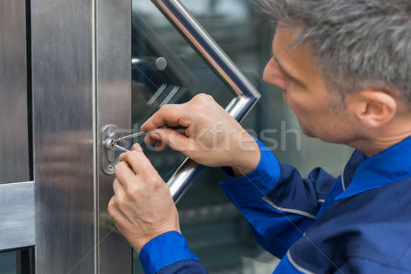 Male Lockpicker Fixing Door Handle At Home Stock photo © AndreyPopov
