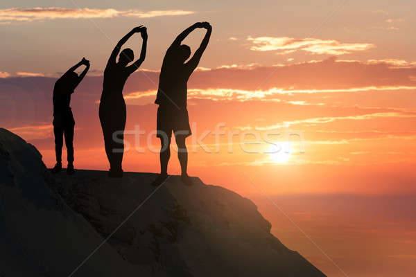 Family Stretching On A Hill Stock photo © AndreyPopov