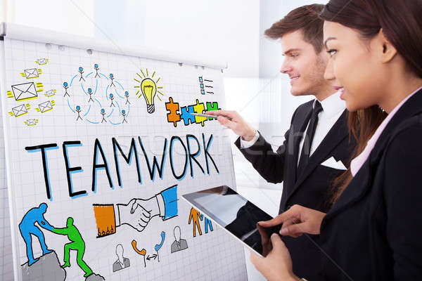 Businesspeople Discussing Teamwork Concept On Flipchart Stock photo © AndreyPopov