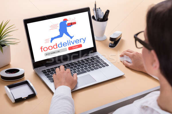 Businesswoman Delivering Food Online Stock photo © AndreyPopov