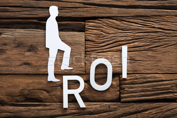 Paper Businessman Climbing ROI Ladder On Wood Stock photo © AndreyPopov