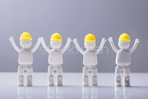 Close-up Of Human Figures With Yellow Hard Hat Stock photo © AndreyPopov